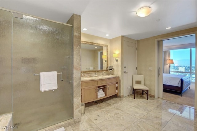 ensuite bathroom with double vanity, a shower stall, a sink, and ensuite bathroom