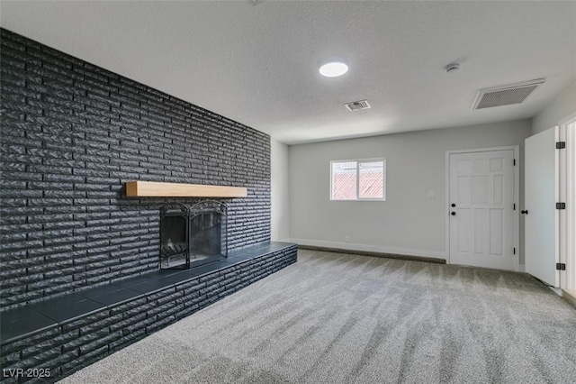 unfurnished living room featuring visible vents, carpet, and a brick fireplace