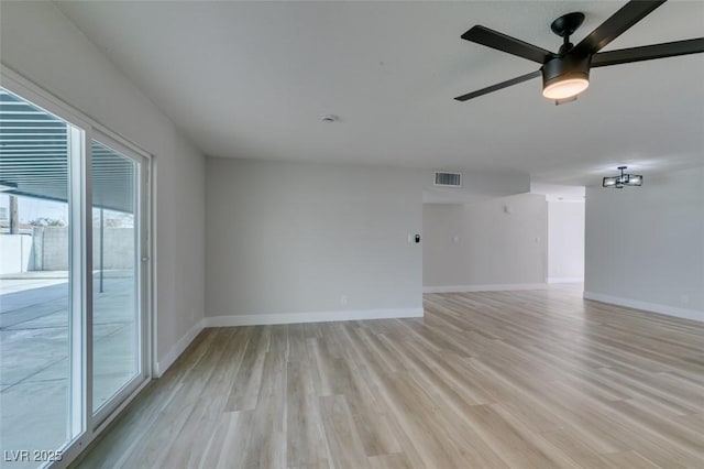 unfurnished room featuring visible vents, baseboards, light wood-style floors, and a ceiling fan