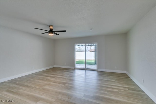 unfurnished room with baseboards, light wood-style floors, a ceiling fan, and a textured ceiling