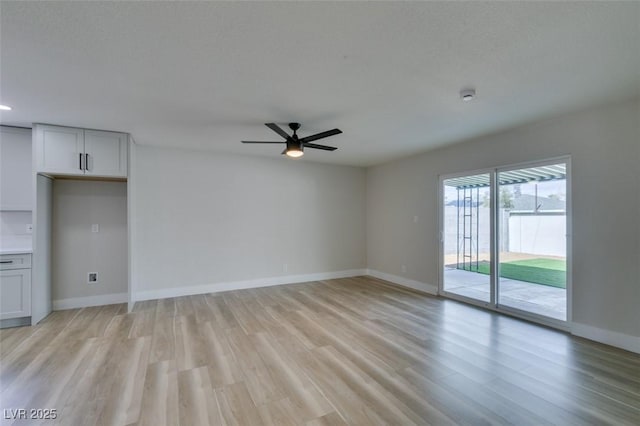 unfurnished living room with baseboards, light wood-style floors, and a ceiling fan