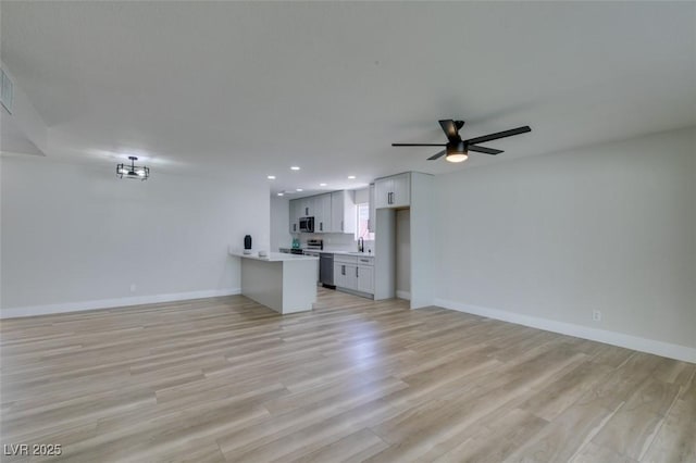 unfurnished living room with recessed lighting, baseboards, light wood-style floors, and a ceiling fan