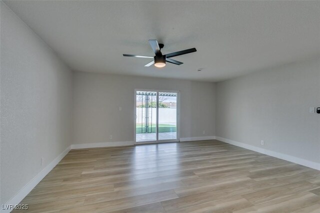 spare room with light wood-style flooring, baseboards, and ceiling fan