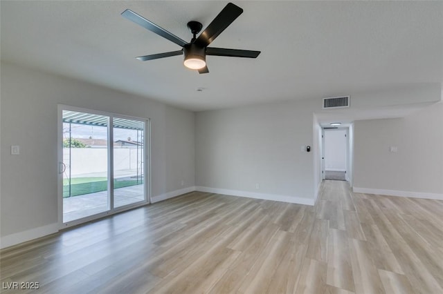 spare room featuring visible vents, baseboards, and light wood-style floors