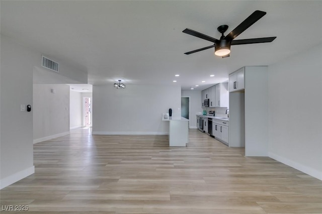 unfurnished living room featuring visible vents, ceiling fan, baseboards, light wood-type flooring, and recessed lighting