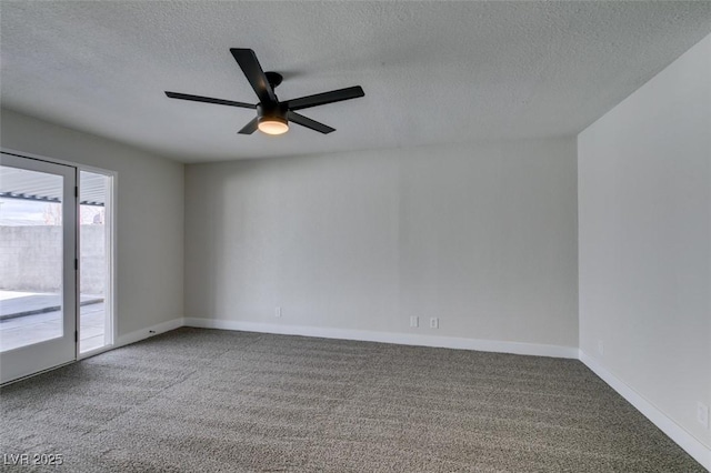 carpeted spare room featuring a textured ceiling, baseboards, and ceiling fan