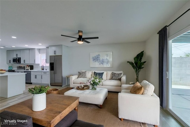 living area featuring light wood-style flooring, recessed lighting, and ceiling fan