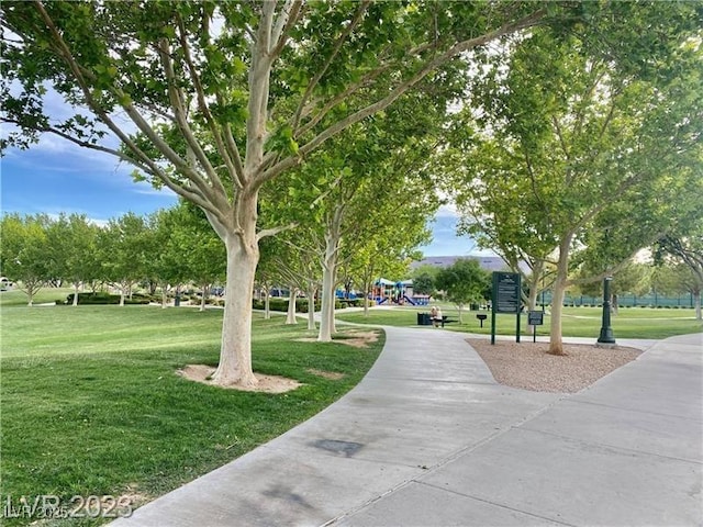 view of property's community with a yard and playground community