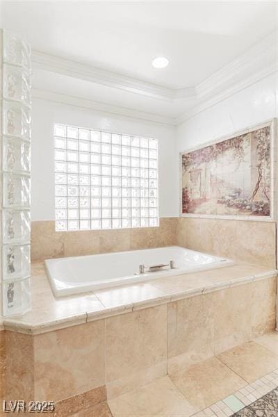 bathroom with a wealth of natural light, a garden tub, crown molding, and tile patterned floors