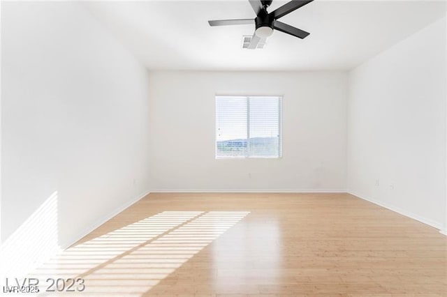 unfurnished room featuring visible vents, ceiling fan, light wood-style flooring, and baseboards