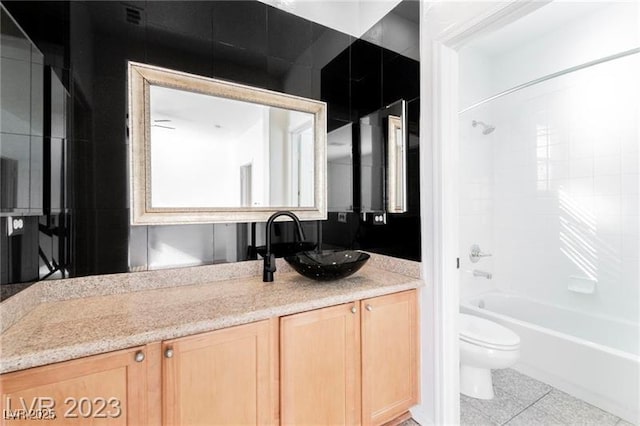 bathroom with  shower combination, vanity, toilet, and tile patterned floors