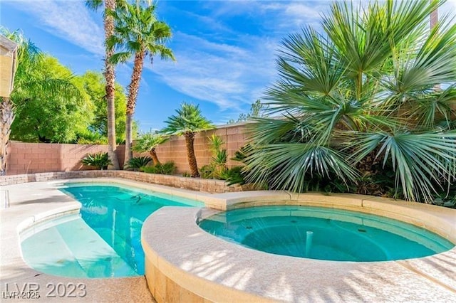 view of swimming pool featuring a fenced in pool, a fenced backyard, and an in ground hot tub