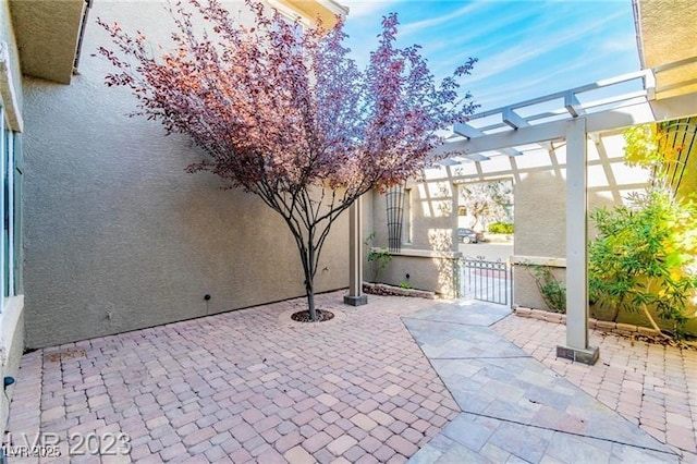 view of patio / terrace featuring a gate, fence, and a pergola