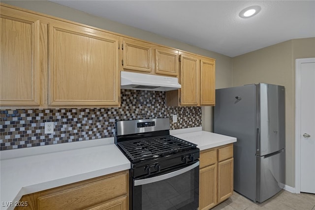 kitchen featuring under cabinet range hood, light countertops, light tile patterned floors, decorative backsplash, and appliances with stainless steel finishes