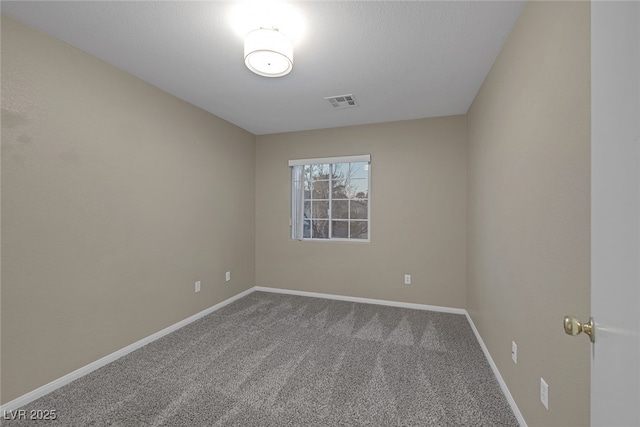 empty room featuring visible vents, carpet, and baseboards