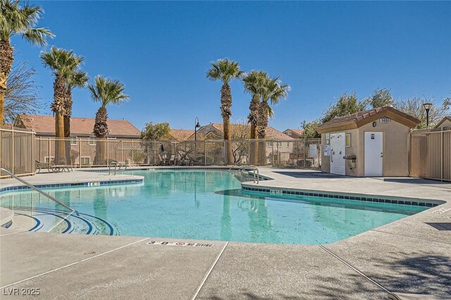 community pool featuring a residential view, a patio, and fence