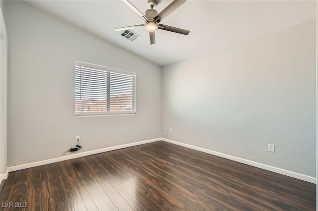 spare room featuring dark wood-style floors, visible vents, baseboards, and a ceiling fan