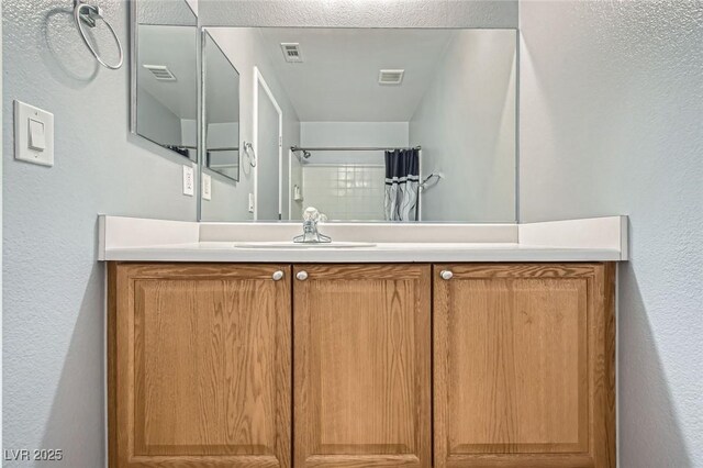 bathroom with visible vents, vanity, and a shower with shower curtain