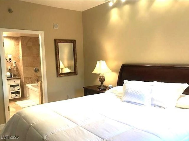 bedroom featuring ensuite bathroom and visible vents