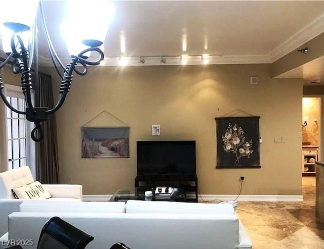 living area featuring baseboards, visible vents, rail lighting, and crown molding