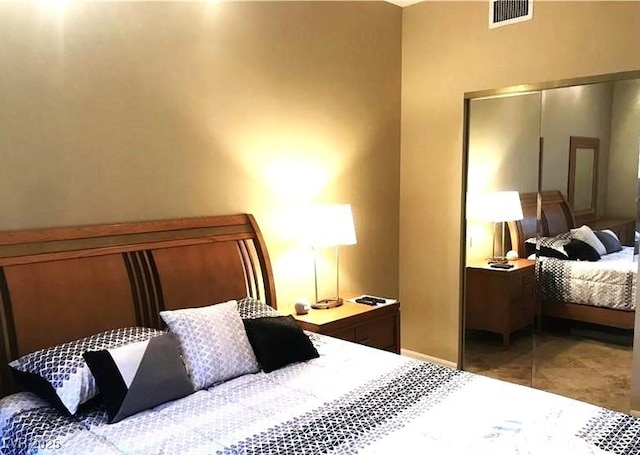 bedroom with a closet, tile patterned flooring, and visible vents