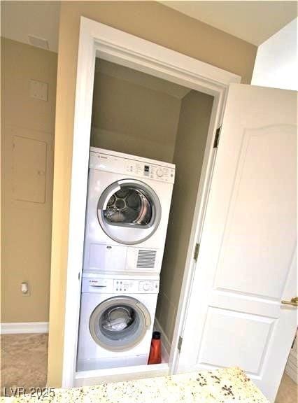 washroom with laundry area and stacked washing maching and dryer