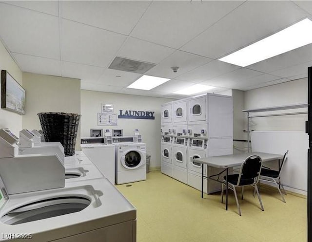 community laundry room featuring stacked washer / drying machine, washing machine and dryer, and light floors