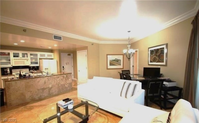 living area featuring ornamental molding, a chandelier, and visible vents