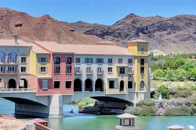 view of building exterior with a water and mountain view