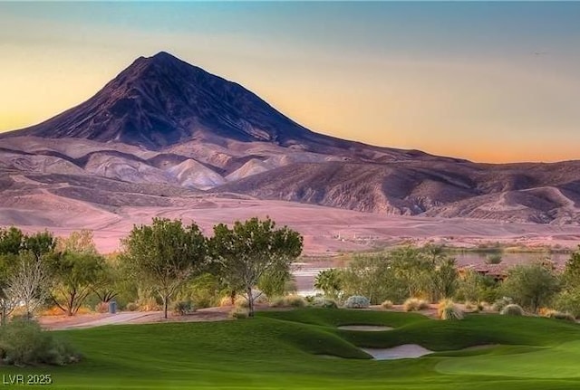 exterior space with a mountain view, golf course view, and a yard