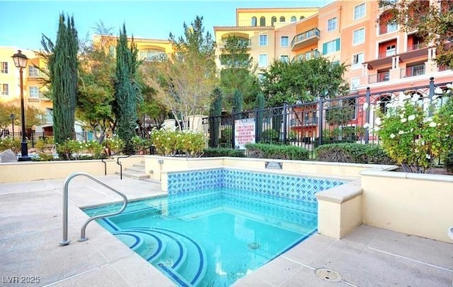 view of swimming pool with a swimming pool and fence