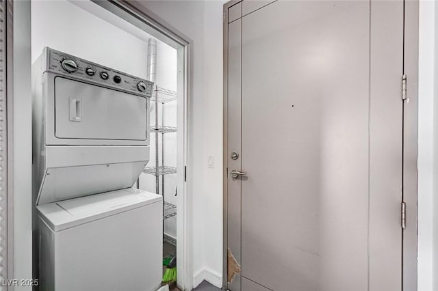 laundry area featuring stacked washer / drying machine and laundry area