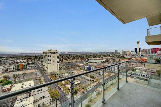 balcony featuring a mountain view and a view of city