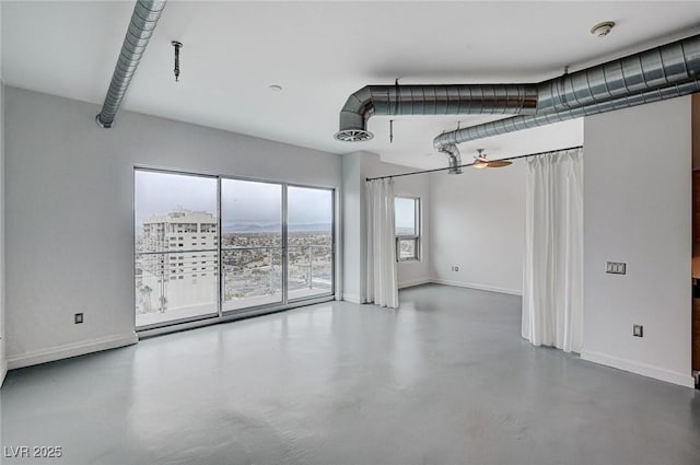 interior space featuring visible vents, finished concrete flooring, and baseboards