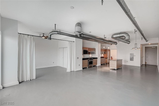 garage with electric panel and baseboards