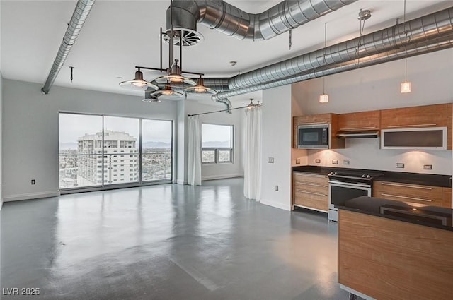 kitchen with dark countertops, built in microwave, open floor plan, brown cabinets, and electric stove