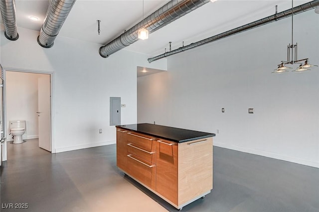 garage featuring electric panel and baseboards