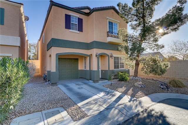 view of front of property featuring concrete driveway, an attached garage, fence, and stucco siding