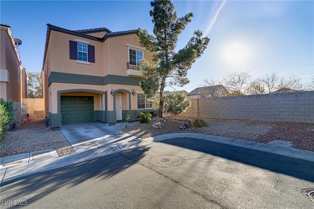 view of front of property featuring concrete driveway, fence, an attached garage, and stucco siding