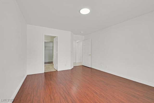 unfurnished room with wood finished floors and baseboards