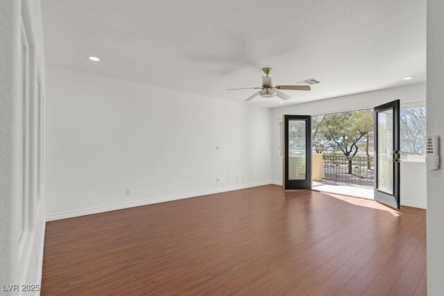 spare room with a ceiling fan, visible vents, baseboards, recessed lighting, and dark wood-style flooring