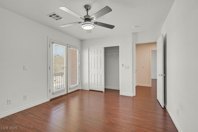 unfurnished bedroom featuring visible vents, baseboards, wood finished floors, and access to outside