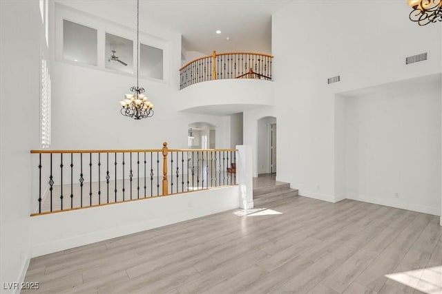 interior space with visible vents, arched walkways, and wood finished floors