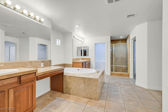 full bathroom with visible vents, a sink, tile patterned flooring, a shower stall, and a bath