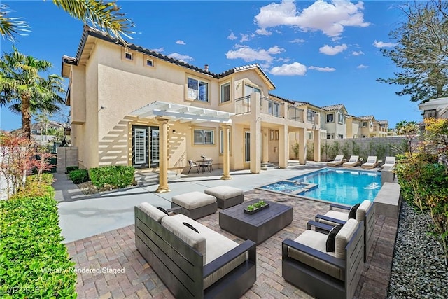 rear view of house featuring fence, a pergola, stucco siding, a patio area, and an outdoor hangout area