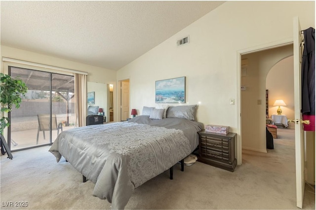 1892 Maricopa Dr, Laughlin, NV 89029 - bedroom featuring light carpet, access to outside, visible vents, and vaulted ceiling