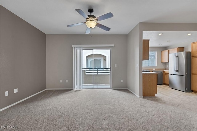 unfurnished living room featuring recessed lighting, light carpet, ceiling fan, and baseboards