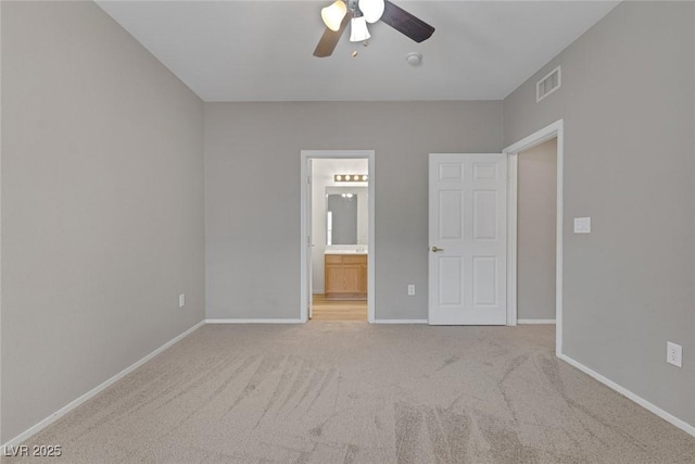 unfurnished bedroom with visible vents, baseboards, a ceiling fan, ensuite bathroom, and carpet