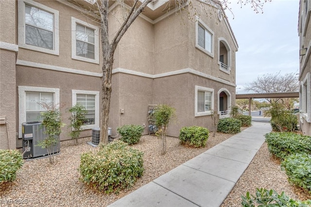 exterior space featuring central AC unit and stucco siding