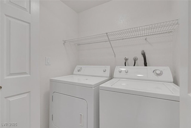 clothes washing area featuring laundry area and washer and clothes dryer